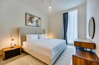 a bedroom with a large bed and a mirror at Comfy family 3BD apartment in Dubai Creek Harbour in Dubai