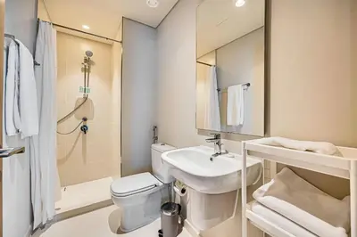 a bathroom with a sink and a toilet and a shower at Comfy family 3BD apartment in Dubai Creek Harbour in Dubai