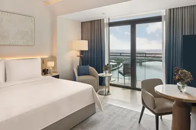 a hotel room with a bed and a balcony at Palace Dubai Creek Harbour in Dubai