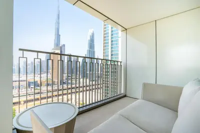 a room with a white couch and a large window at RH - Beautiful Burj Khalifa View, 03BR with Maid's Room, 7 mins walk to Dubai Mall in Dubai