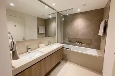 a bathroom with two sinks and a large mirror at RH - Beautiful Burj Khalifa View, 03BR with Maid's Room, 7 mins walk to Dubai Mall in Dubai