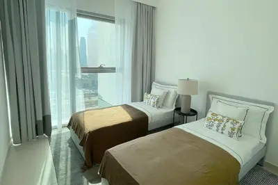 two beds in a hotel room with a large window at RH - Beautiful Burj Khalifa View, 03BR with Maid's Room, 7 mins walk to Dubai Mall in Dubai