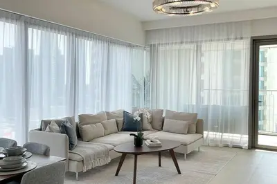 a living room with a couch and a table at RH - Beautiful Burj Khalifa View, 03BR with Maid's Room, 7 mins walk to Dubai Mall in Dubai