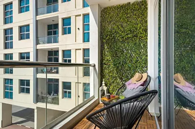a balcony with a chair and a building at Cozy Dubai Marina Design Studio close to Jumeirah Beach, Mall & Metro in Dubai