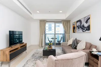 a living room with a couch and a tv at Vibrant - Prime Location Dubai Marina - Near Metro in Dubai
