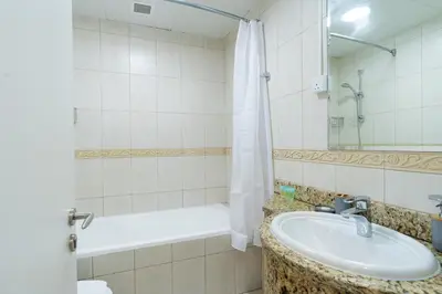 a bathroom with a sink and a bath tub at Vibrant - Prime Location Dubai Marina - Near Metro in Dubai