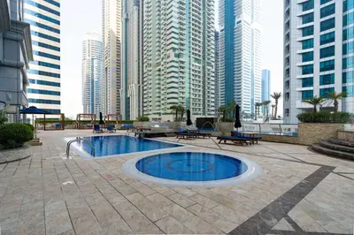 a pool in the middle of a city with tall buildings at Vibrant - Prime Location Dubai Marina - Near Metro in Dubai