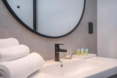 a bathroom with a sink and a mirror at Pristine 1 Bedroom - Business Bay in Dubai