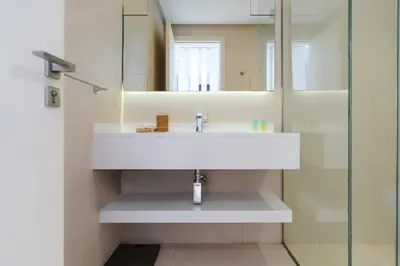 a bathroom with a white sink and a mirror at Comfortable 2 Bed - Near Marina Mall in Dubai