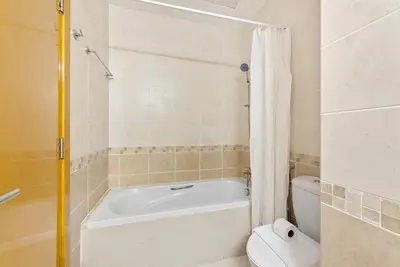 a bathroom with a white tub and a toilet at Silkhaus New studio in Silicon Oasis ASB Tower in Dubai