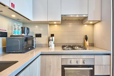 a kitchen with a sink and a stove top oven at STAY BY LATINEM Luxury 1BR Holiday Home W 2709 Near Burj Khalifa in Dubai
