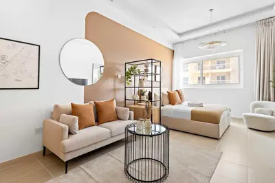 a living room with a couch and a bed at Silkhaus New Studio in ASB Tower Walking distance to mall in Dubai