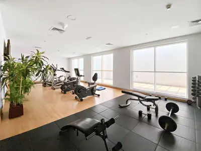 a gym with cardio equipment and a large window at Silkhaus New Studio in ASB Tower Walking distance to mall in Dubai