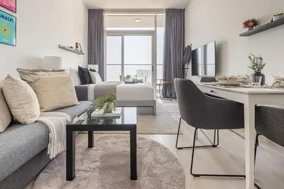 a living room with a couch and a table at Frank Porter - Bloom Heights in Dubai