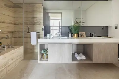 a large bathroom with a sink and a shower at Frank Porter - The Sterling by Omniyat in Dubai