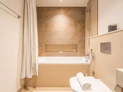 a bathroom with a toilet and a bath tub at Blazing 1Br in Downtown Views in Dubai