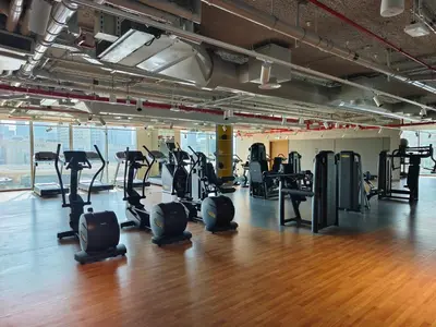 a gym with treadmills and elliptical machines at Blazing 1Br in Downtown Views in Dubai