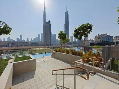 a swimming pool with a city skyline in the background at Blazing 1Br in Downtown Views in Dubai