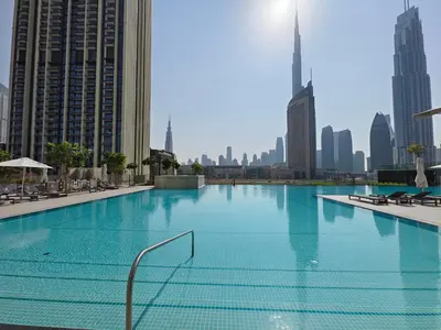 a large swimming pool in the middle of a city at Blazing 1Br in Downtown Views in Dubai