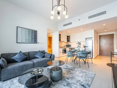 a living room with a couch and a table at Blazing 1Br in Downtown Views in Dubai