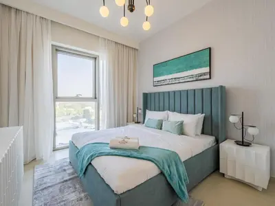 a bedroom with a large bed and a large window at Blazing 1Br in Downtown Views in Dubai