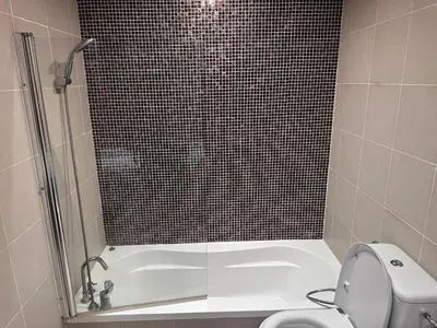 a bathroom with a shower and a toilet and a tub at The Sand Castle - Ubora Residence Tower, Business Bay, Burj Khalifa View in Dubai