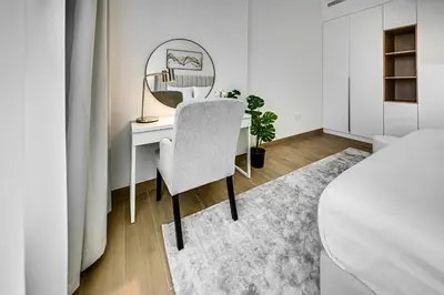 a bedroom with a desk with a mirror and a chair at Amazing 1 bedroom in Port De La Mer near the sea in Dubai