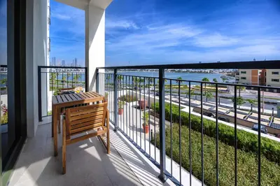 a balcony with a bench and a view of a street at Amazing 1 bedroom in Port De La Mer near the sea in Dubai