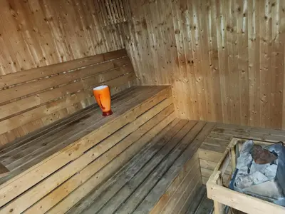 an orange candle sitting in a wooden sauna at Elite 6 Residence - Sports City by Golden Casa in Dubai