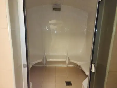 a white shower in a bathroom with a tile floor at Elite 6 Residence - Sports City by Golden Casa in Dubai