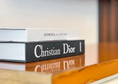 a pile of books sitting on a shelf at Cool Studio near to Metro & Beach in Dubai Marina in Dubai