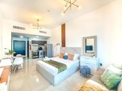 a large bedroom with a bed and a kitchen at Cool Studio near to Metro & Beach in Dubai Marina in Dubai
