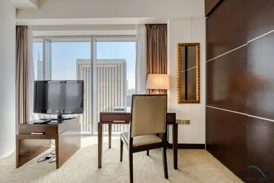 a room with a desk with a television and a desk with a chair at Overlooking Marina Views Next to Marina Mall 1BR Unit, The Address Residences, Dubai Marina by Deluxe Holiday Homes in Dubai