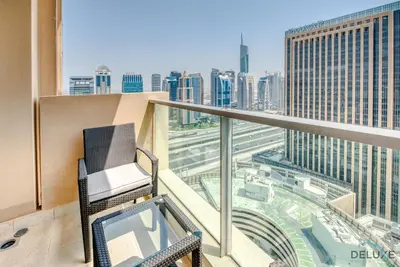 a balcony with a chair and a view of a city at Overlooking Marina Views Next to Marina Mall 1BR Unit, The Address Residences, Dubai Marina by Deluxe Holiday Homes in Dubai