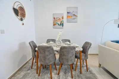 a dining room with a table and chairs at 54 Floor Palm & Sea View Dubai Marina. LUX / NEW in Dubai