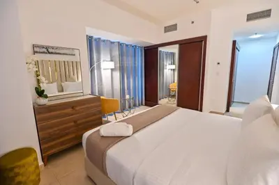 a bedroom with a large white bed and a mirror at 54 Floor Palm & Sea View Dubai Marina. LUX / NEW in Dubai