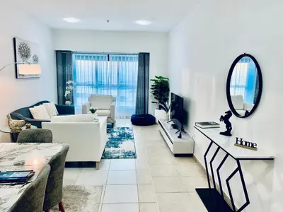 a living room with a couch and a mirror at 54 Floor Palm & Sea View Dubai Marina. LUX / NEW in Dubai