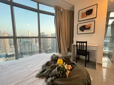 a bedroom with a bed with a view of a city at Coliving sharing Hostel 1 in Dubai