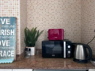 a microwave sitting on top of a kitchen counter at Coliving sharing Hostel 1 in Dubai