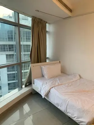 a bed in a room with a large window at Coliving sharing Hostel 1 in Dubai