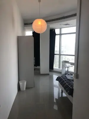a living room with a couch and a light fixture at Coliving sharing Hostel 1 in Dubai