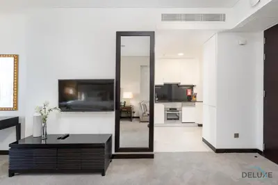a living room with a mirror and a table at Urban Studio at The Address Residences Dubai Marina by Deluxe Holiday Homes in Dubai