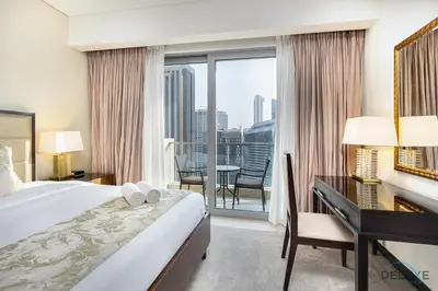 a hotel room with a bed and a desk and a window at Urban Studio at The Address Residences Dubai Marina by Deluxe Holiday Homes in Dubai