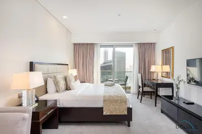 a bedroom with a bed and a desk and a television at Urban Studio at The Address Residences Dubai Marina by Deluxe Holiday Homes in Dubai