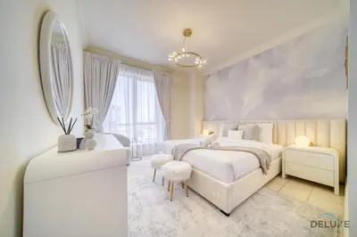 a white bedroom with two beds and a mirror at Urban 2BR at Al Mesk Tower Dubai Marina by Deluxe Holiday Homes in Dubai