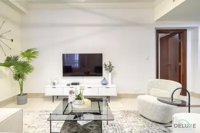 a white living room with a tv and a couch at Urban 2BR at Al Mesk Tower Dubai Marina by Deluxe Holiday Homes in Dubai