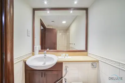 a bathroom with a sink and a large mirror at Urban 2BR at Al Mesk Tower Dubai Marina by Deluxe Holiday Homes in Dubai