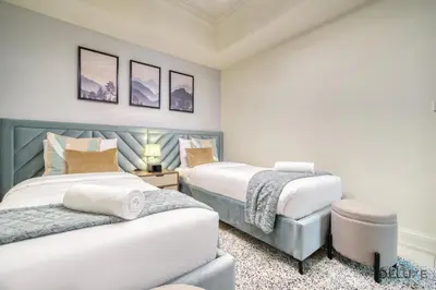 a bedroom with two beds and a chair in it at Urban 2BR at Al Mesk Tower Dubai Marina by Deluxe Holiday Homes in Dubai