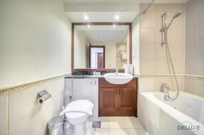 a bathroom with a toilet and a sink and a tub at Urban 2BR at Al Mesk Tower Dubai Marina by Deluxe Holiday Homes in Dubai