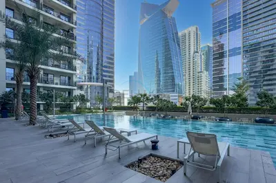 a pool in the middle of a city with buildings at Limited Time Offer Modern 1BR at DAMAC Zada Tower by Deluxe Holiday Homes in Dubai